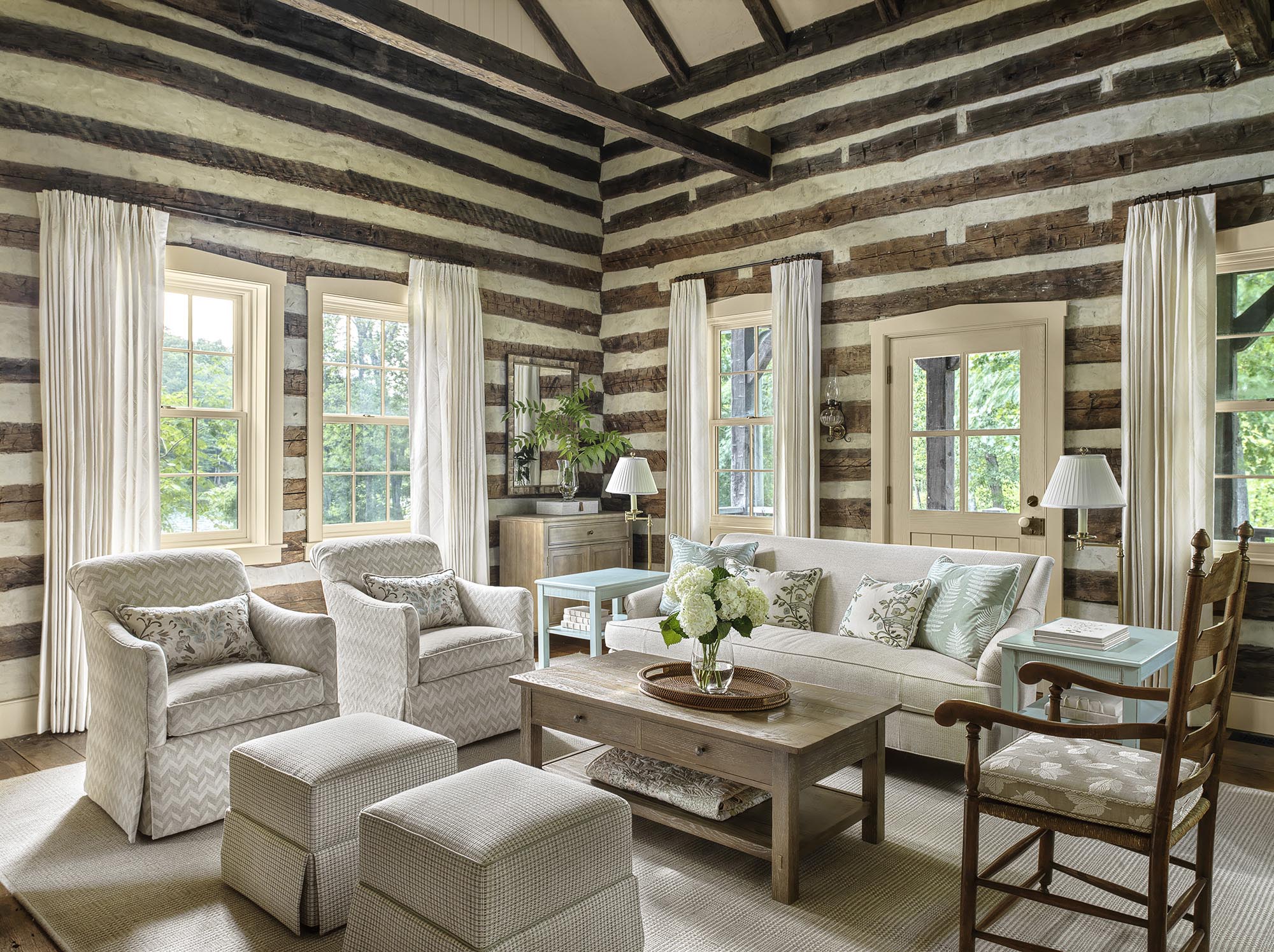 Luxury wooden lodge interiors with beam ceilings and white furniture by Ättlingar