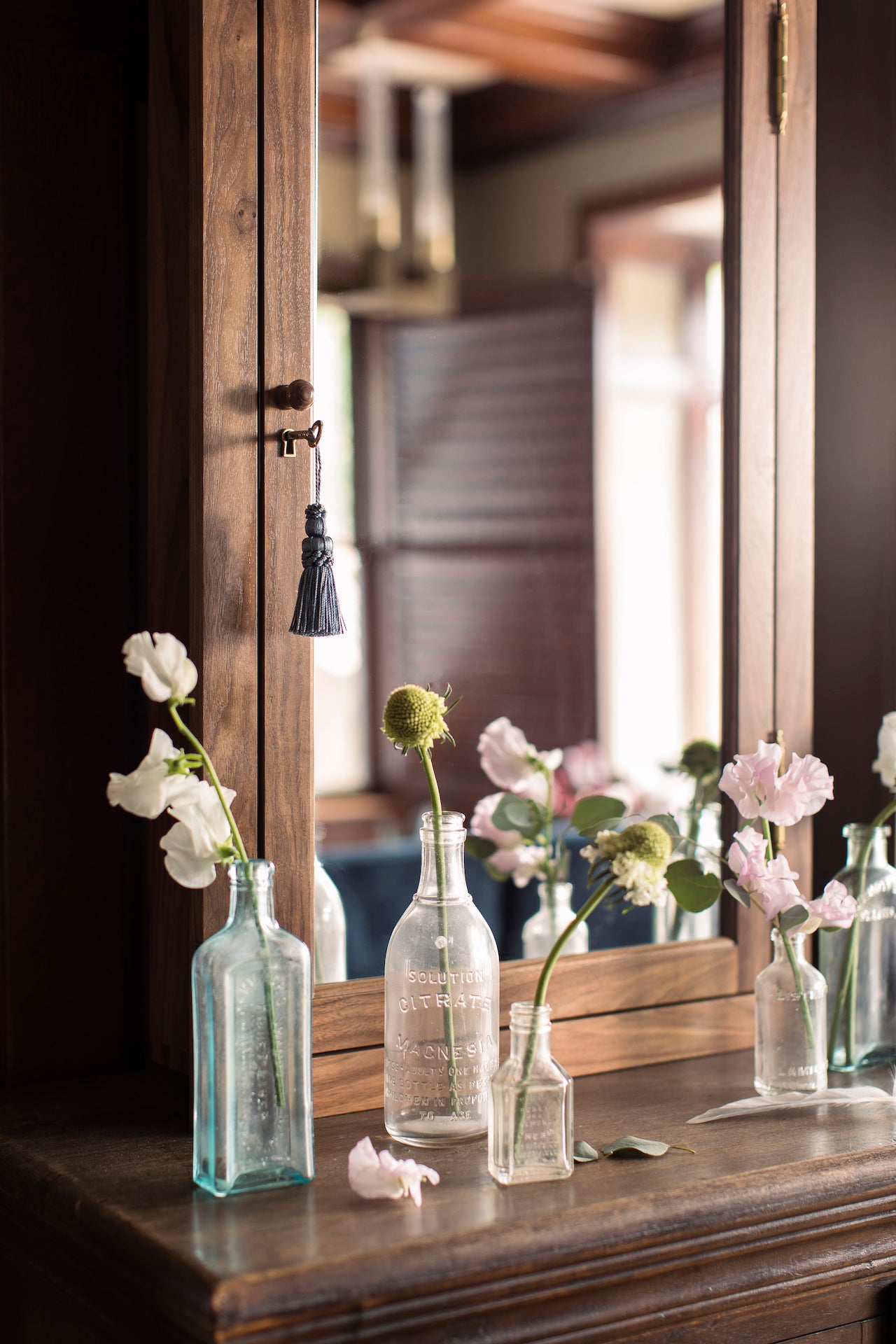 Maria Medicine Cabinet styled above bathroom vanity with multiples vases containing flowers– Luxury bathroom storage by Ättlingar