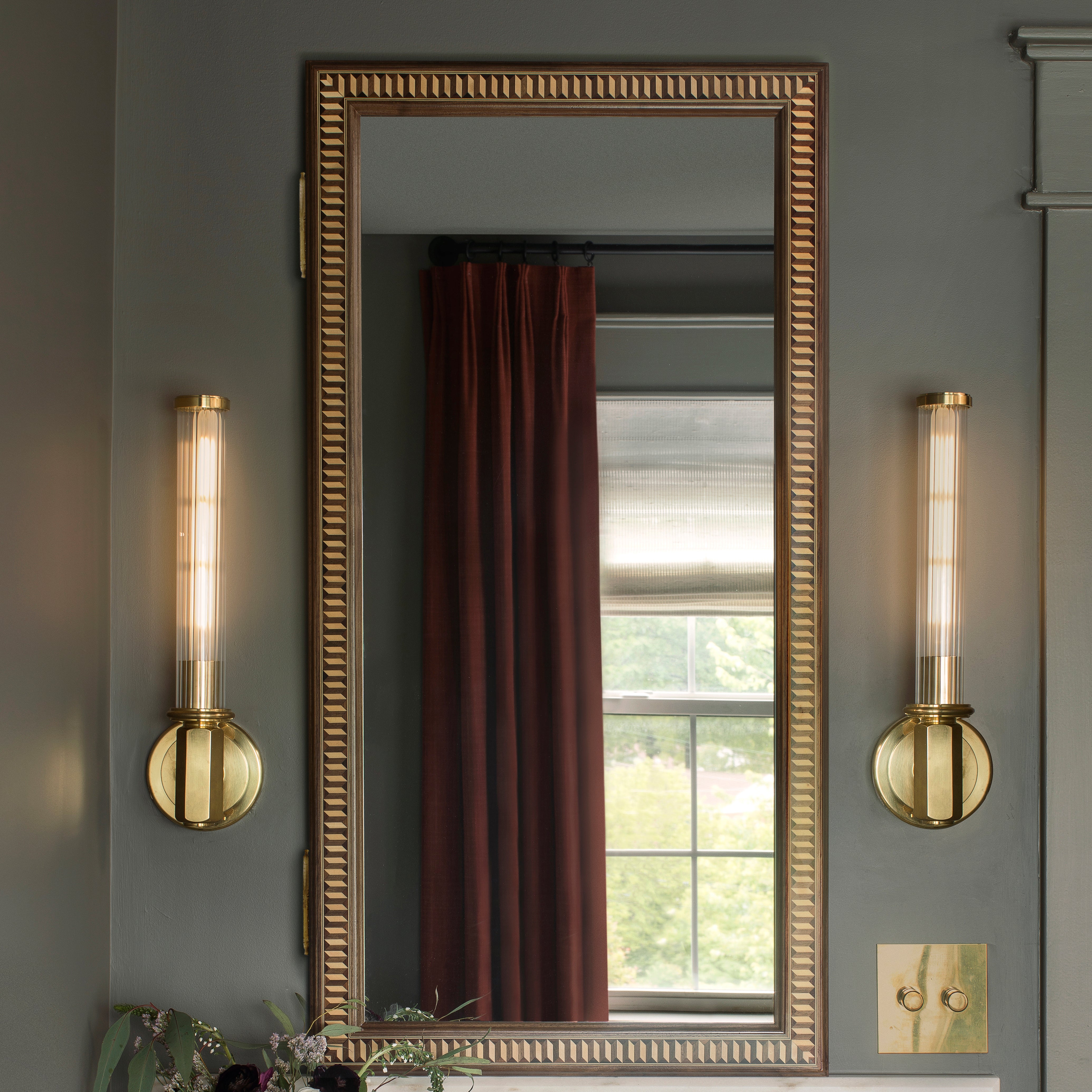 Photo of grey background with burgandy curtains and Ättlingar Mirror