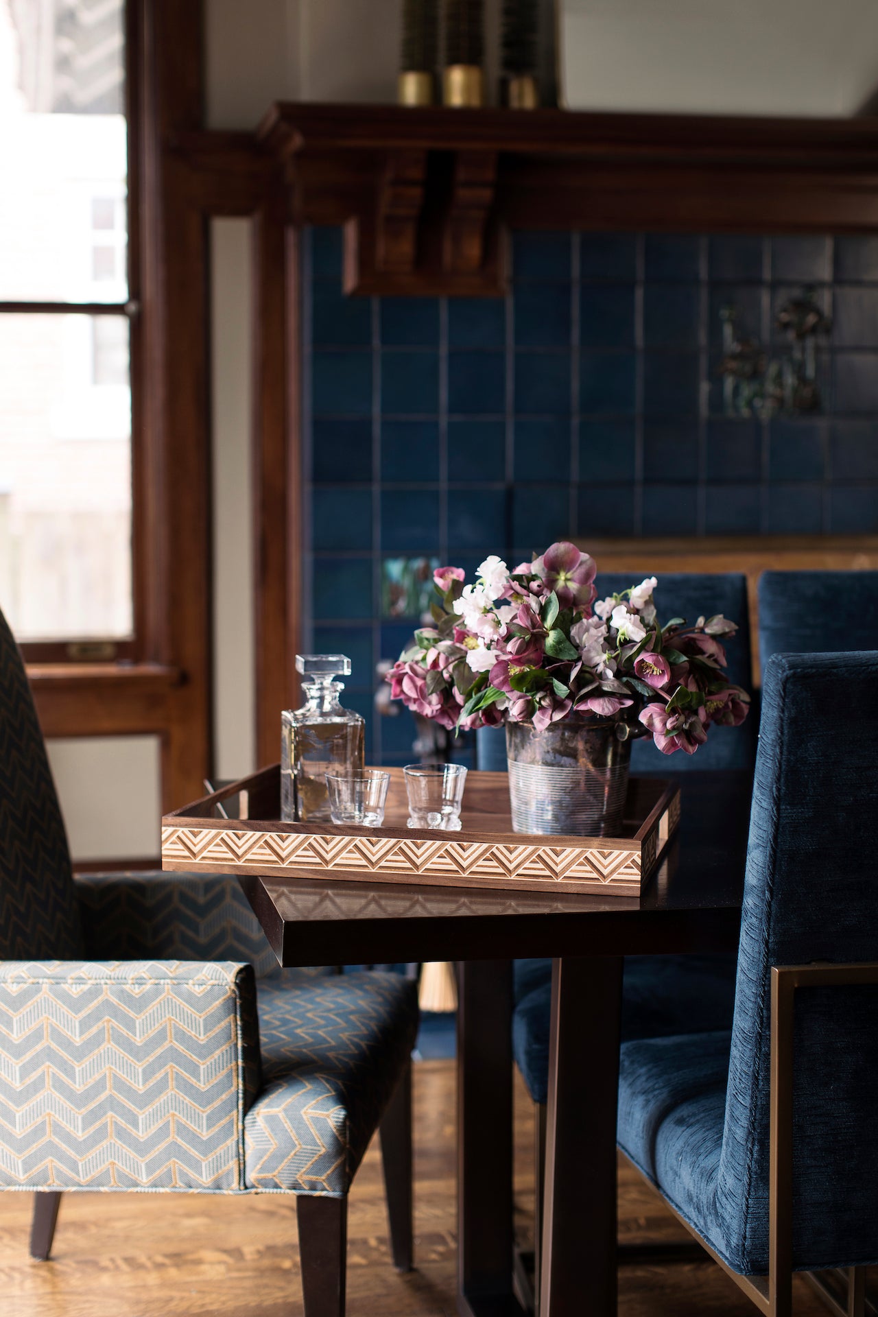 Haupt Tray in Walnut in historic-inspired interior with blue tiled wall and chairs – Handcrafted wood tray by Ättlingar