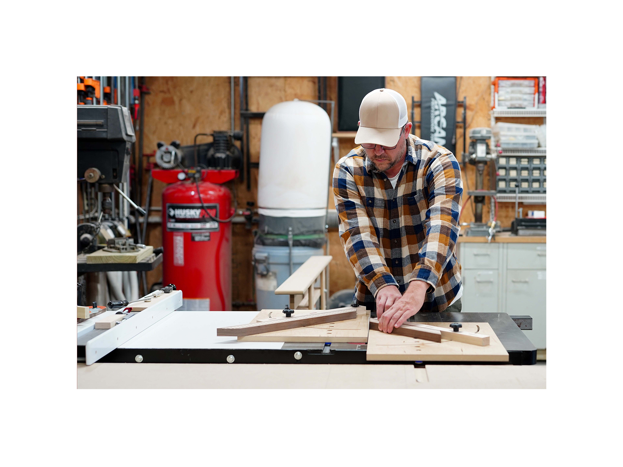 Woodworker putting together a mirror frame in his shop