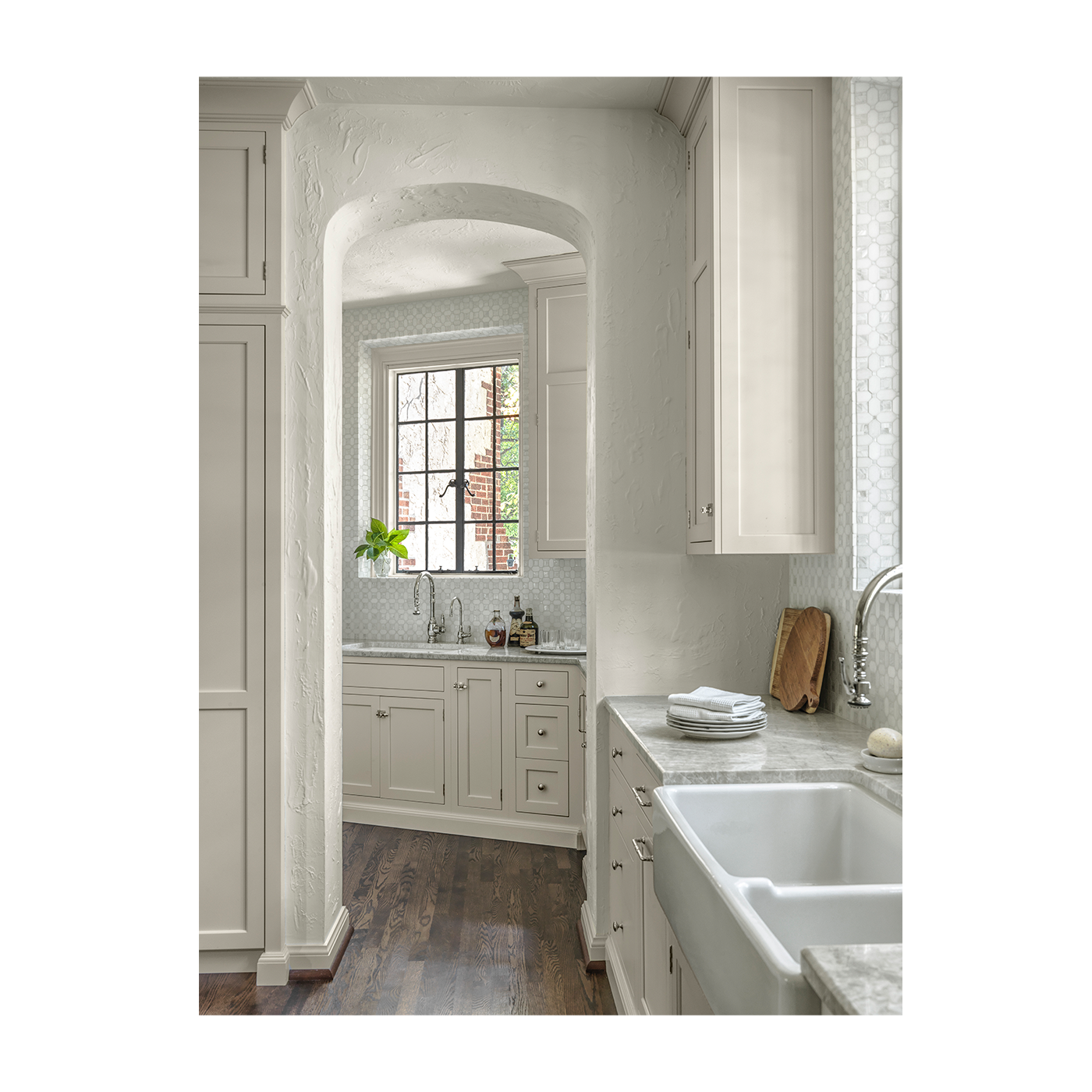 Modern kitchen with white cabinets, marble countertops, and a large window.  Interior Design Project for Ättlingar.