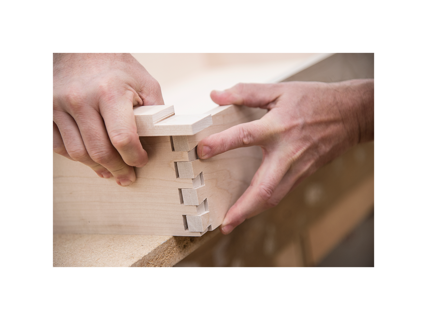 Pair of hands putting together a mirror frame