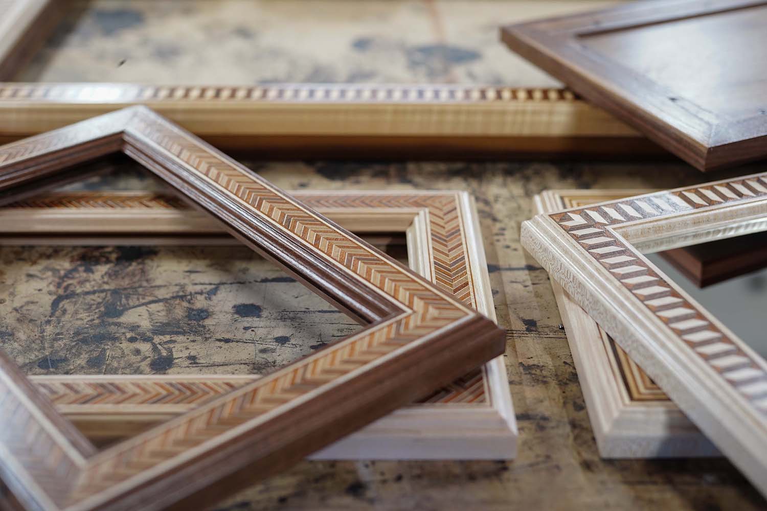 Handcrafted Mirror Frames in a pile on a work table